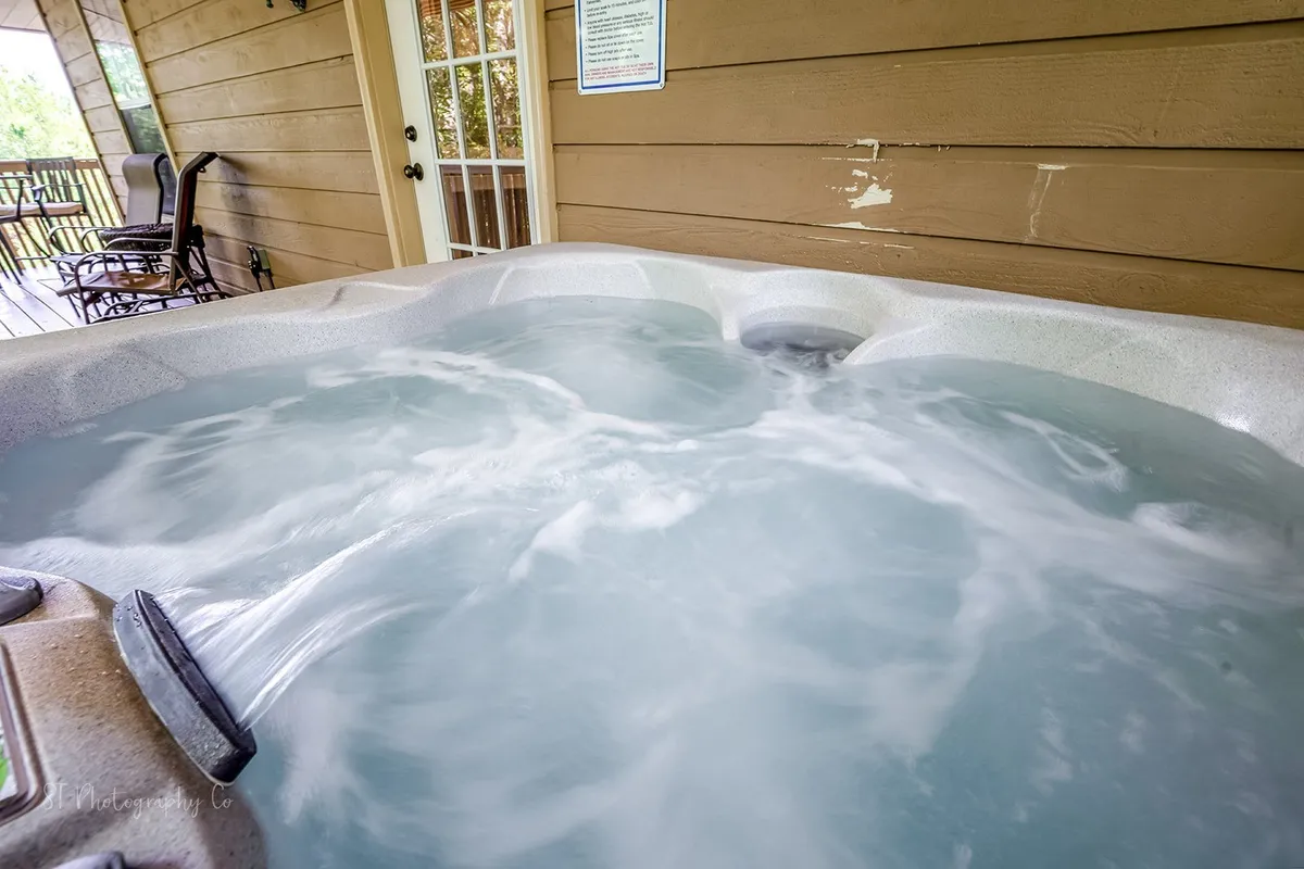 This image features a hot tub with water jets inside a cozy area, suggesting relaxation and sociability. The indoor hot tub hints at opportunities for unwinding after a day of adventure while still enjoying views of the outdoors through windows (if present).